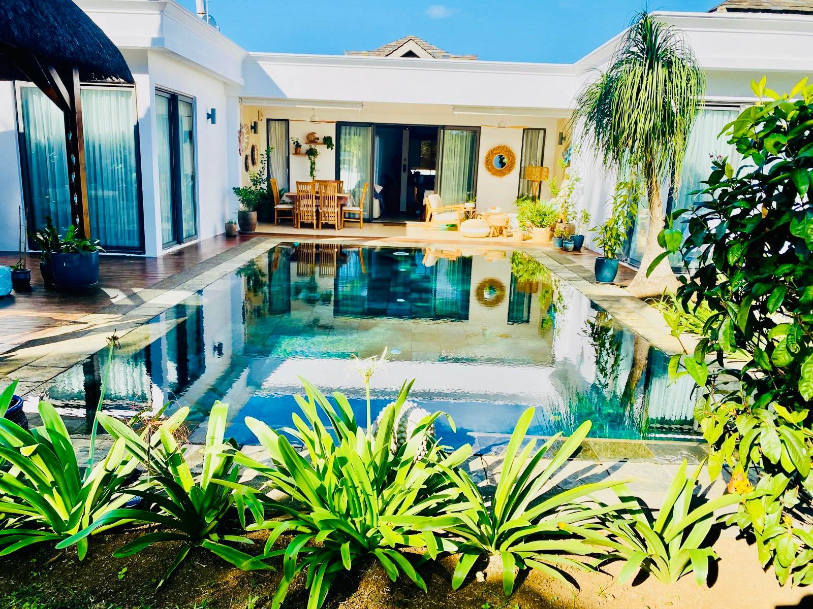 Villa courtyard around a long swimming pool