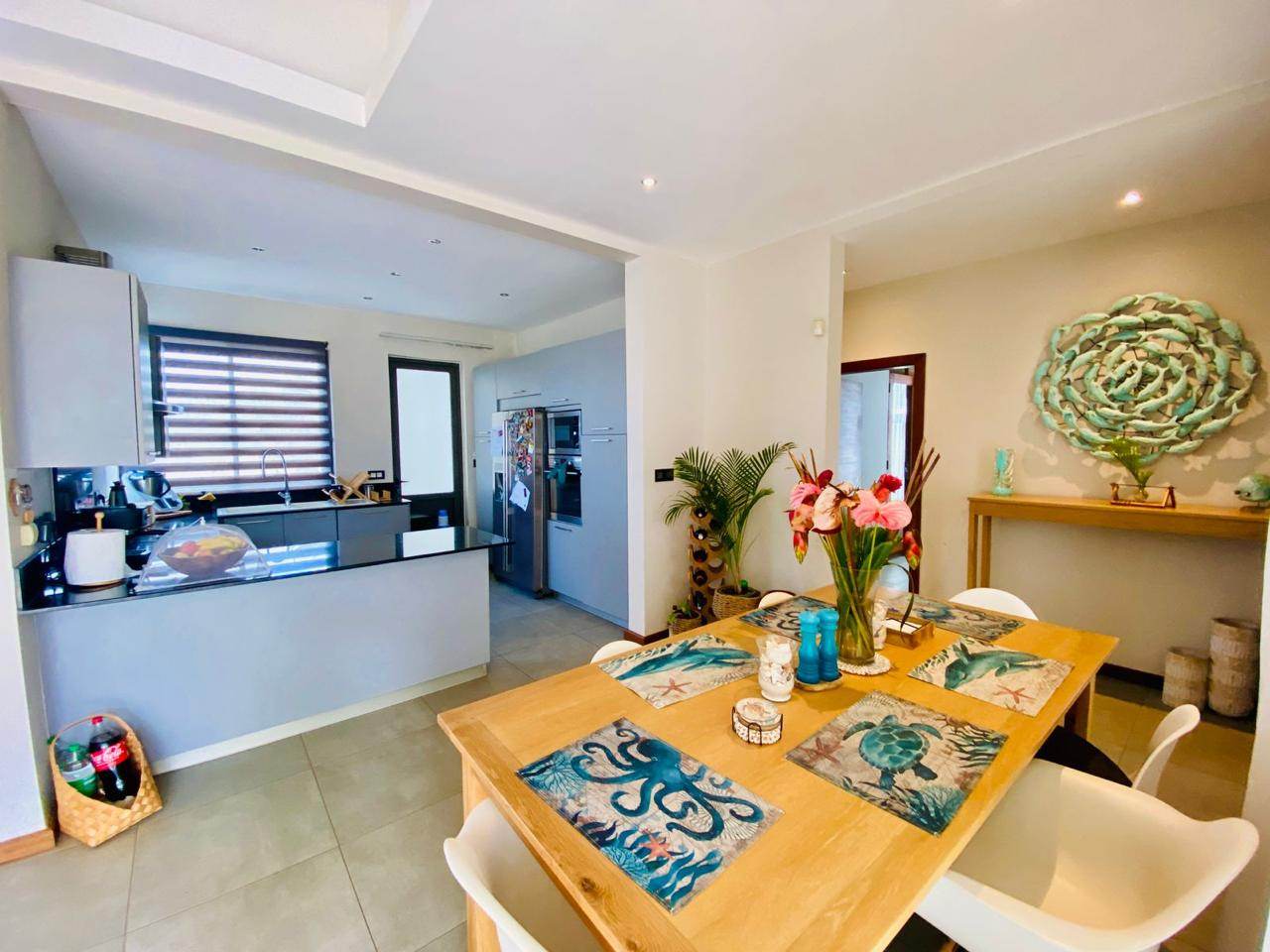 Modern kitchen with a set dining table and fresh flowers
