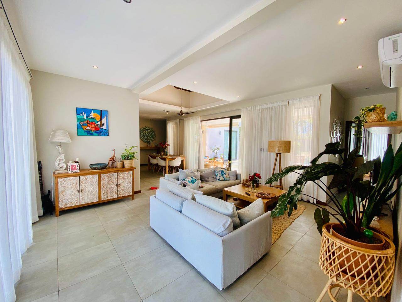 Bright living room with white sofas and plants